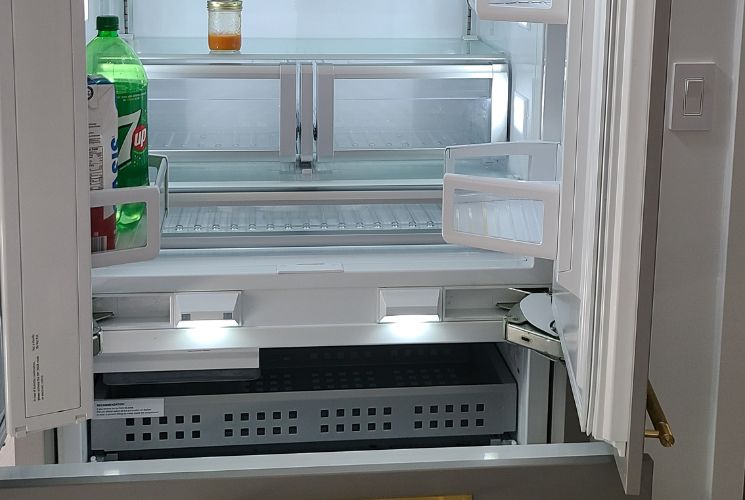 technician fixing fridge compressor