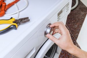 man repairing appliance