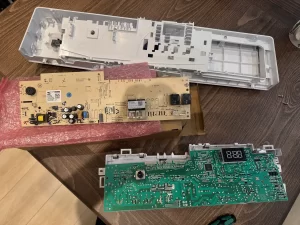 Replacement main control board beside the control panel assembly taken out of the Blomberg dryer