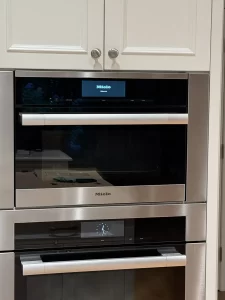 Built-in Miele oven in a white kitchen wall cabinet in Surrey, BC