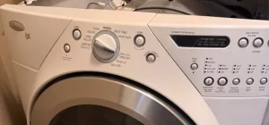 Whirlpool Duet front-load dryer with the top panel lifted for diagnosis in Surrey, BC